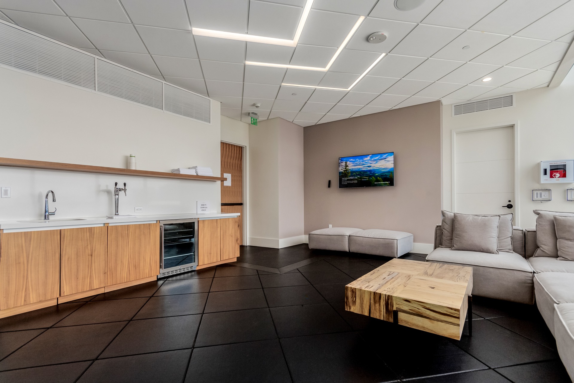 Lounge area in the fitness center with seating and a refreshment counter