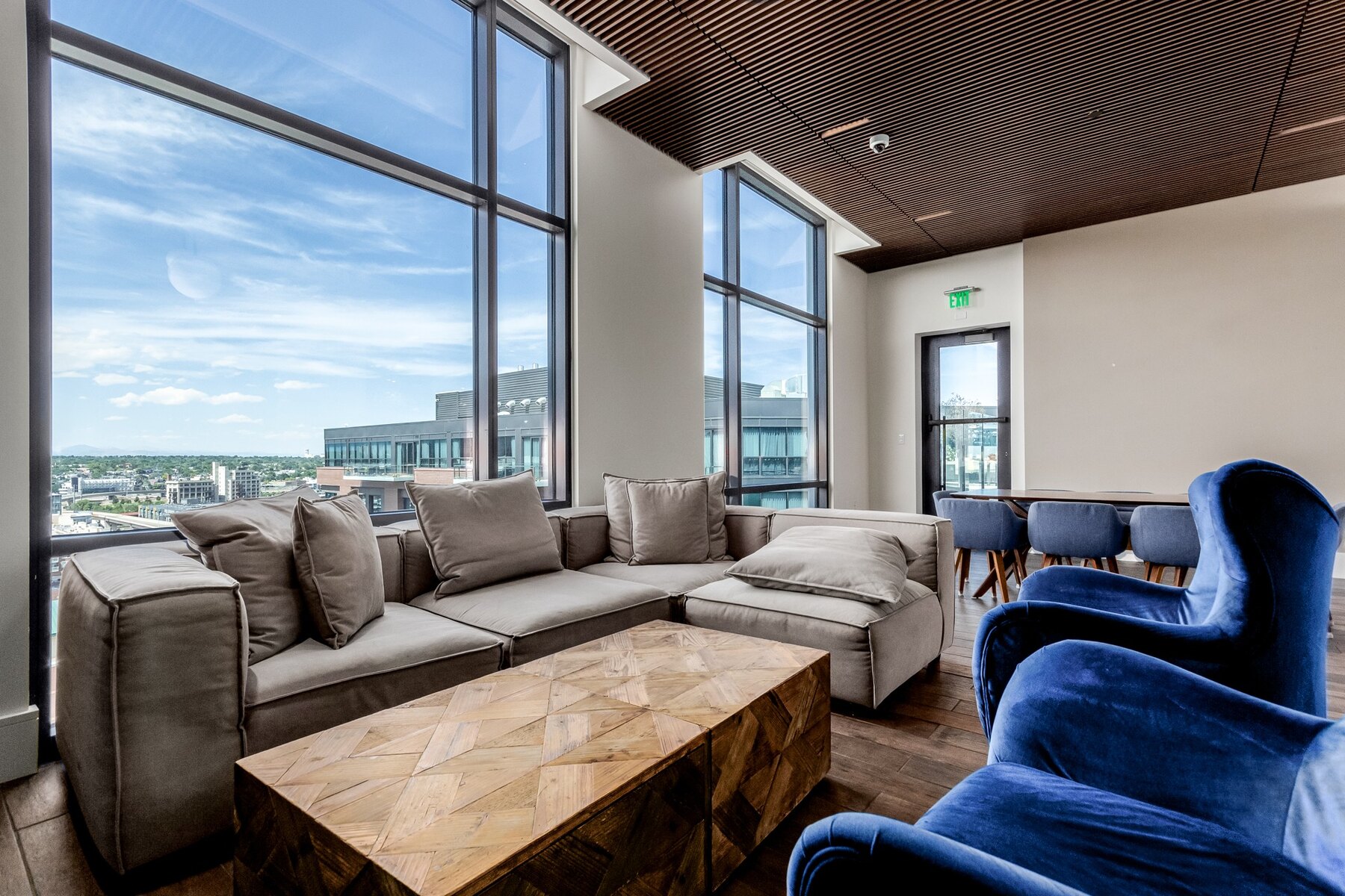 Residents' lounge with floor-to-ceiling windows and skyline views