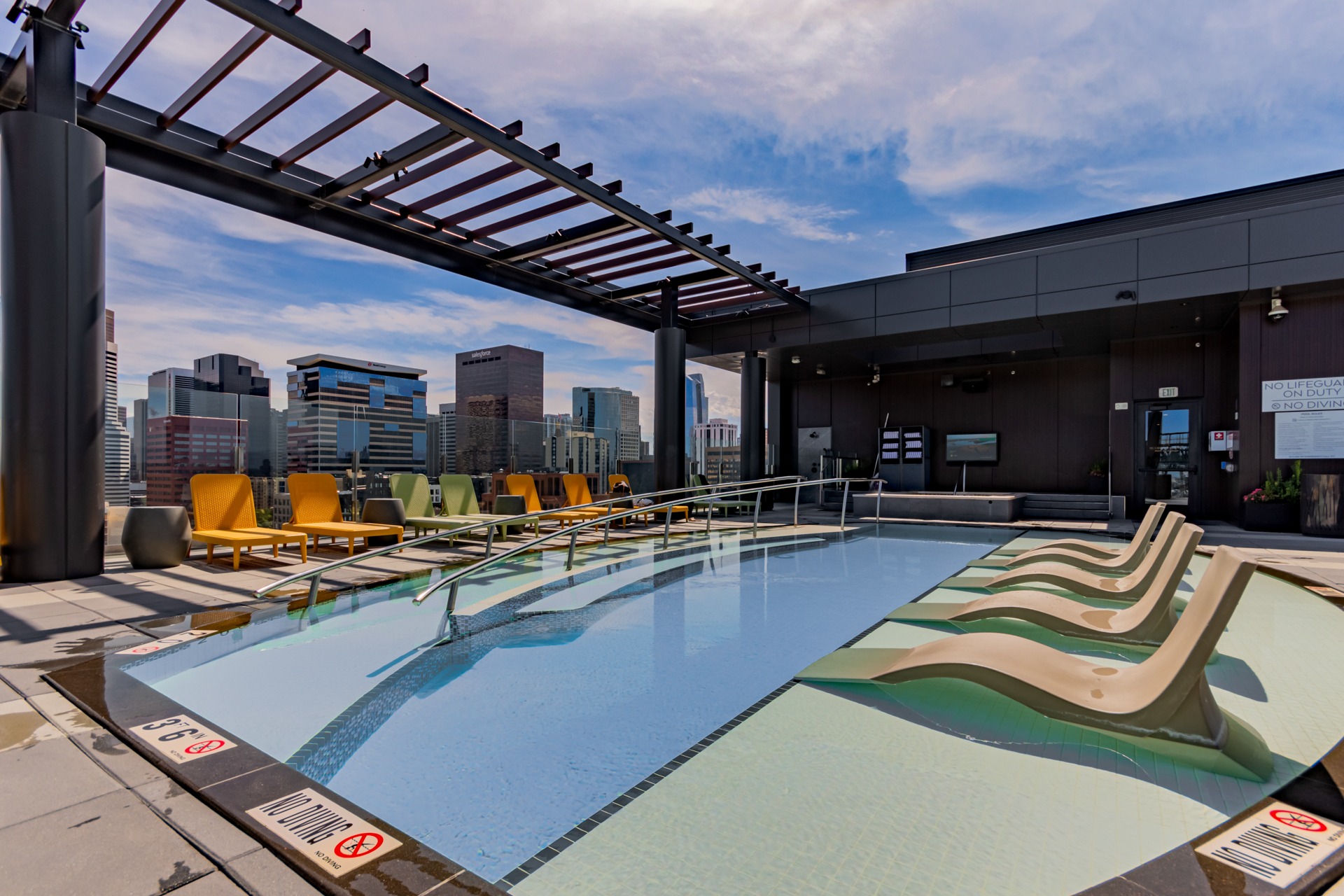 Year-round rooftop swimming pool with lounge seating and city views