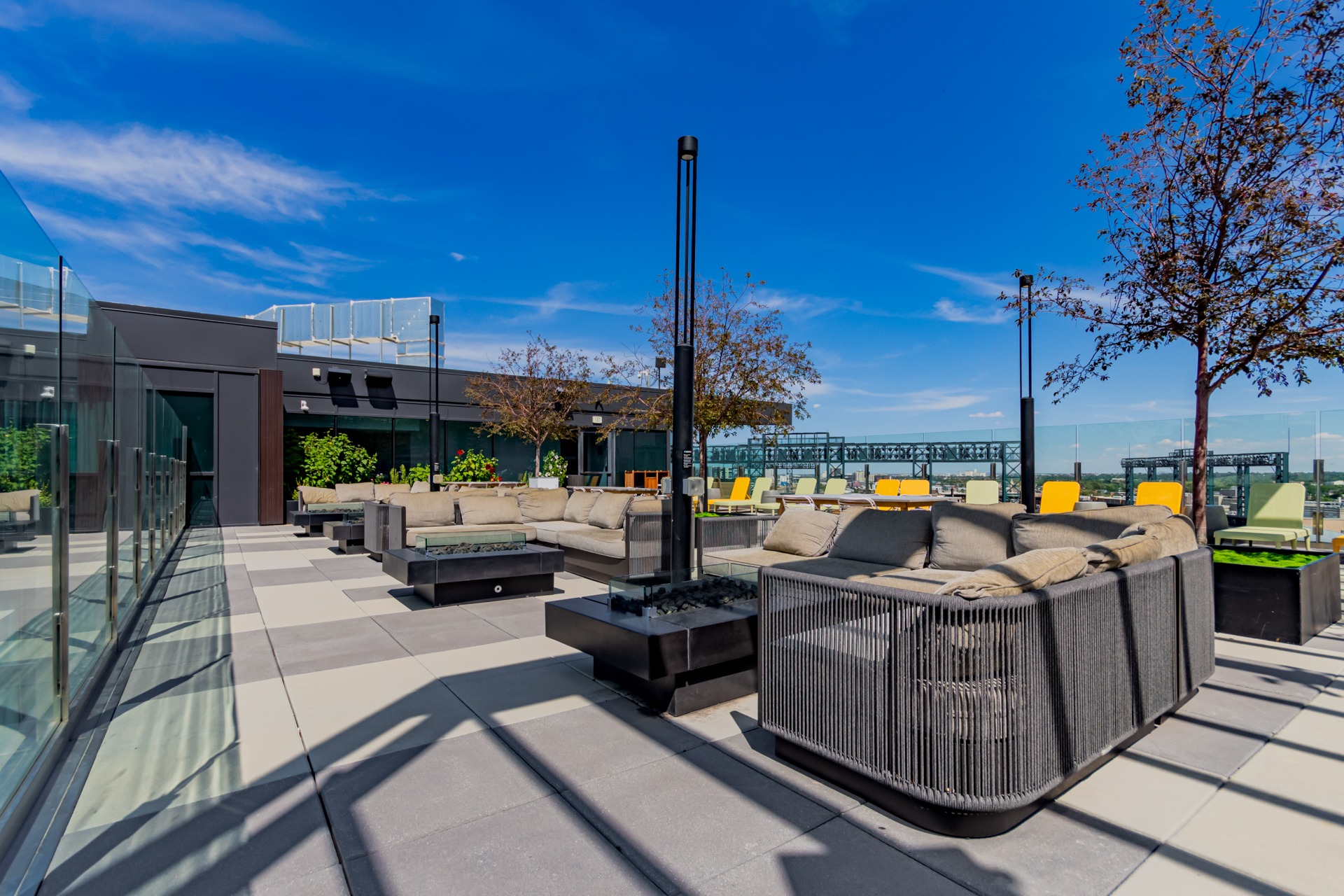 Expansive rooftop terrace with fire pits, conversation areas and city views